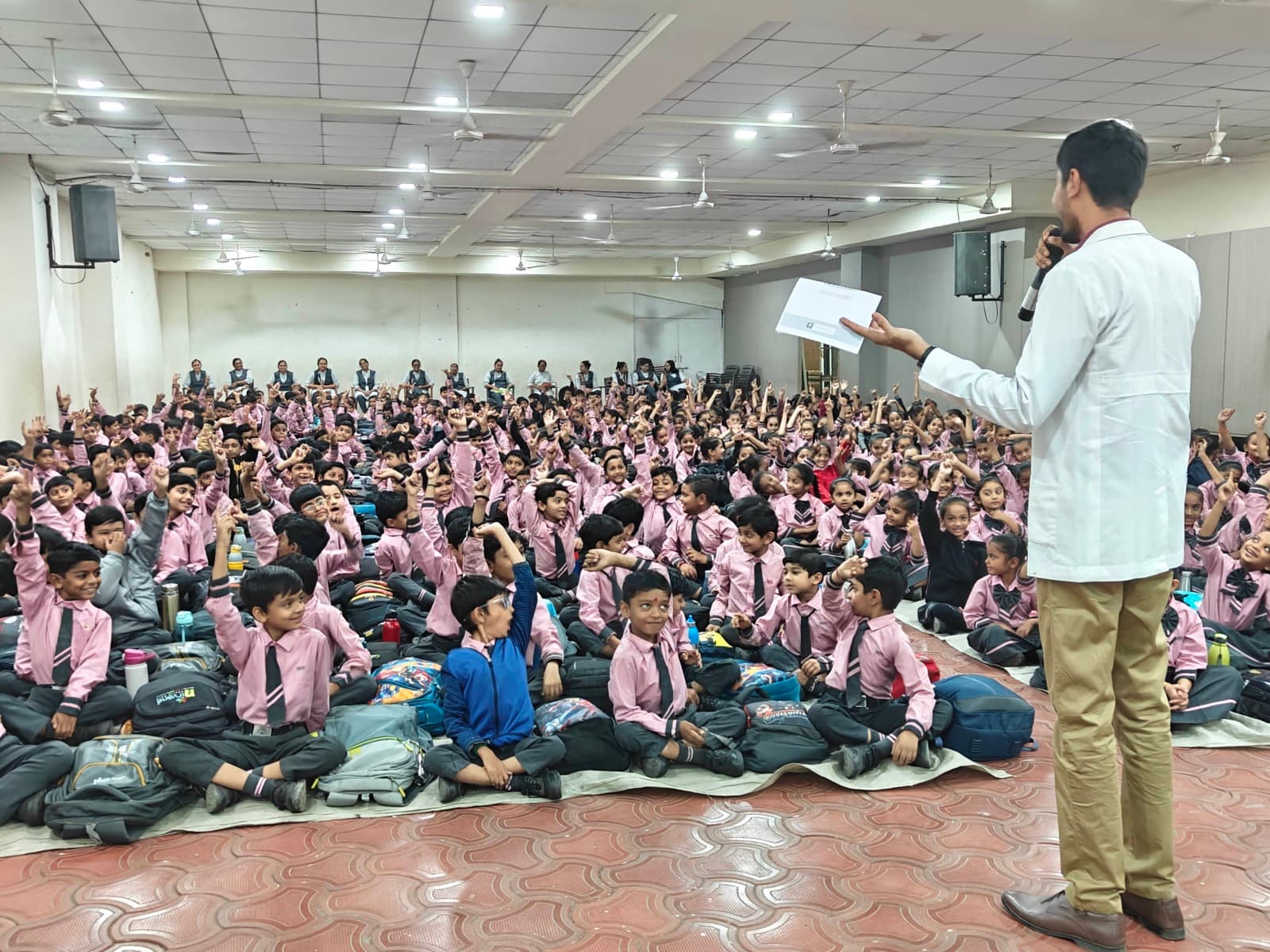 Aarogyam dentist addressing school assembly on oral hygiene